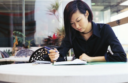Woman Writing in Note Book