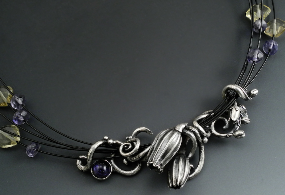 Necklace with botanical elements by Holly Gage of sterling metal clay with stones of tanzanite and citrine