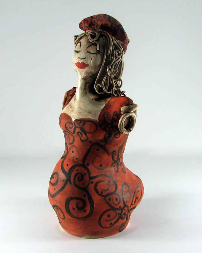 ©Jeanine van der Loo, Doll 5. Ceramic, white earthenware, manganese wash, velvet, 10 inches tall. Used with permission. 