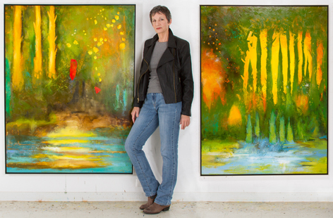 Leslie Neumann with her paintings Beauty Deep Within and Fateful, Faithful. Each 60 x 45 inches.