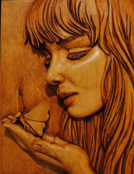 ©James Harris, Girl With Butterfly. Basswood, 14 x 10 x 2 inches. Used with permission.