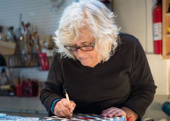 Philadelphia artist Dora Ficher working in her studio.