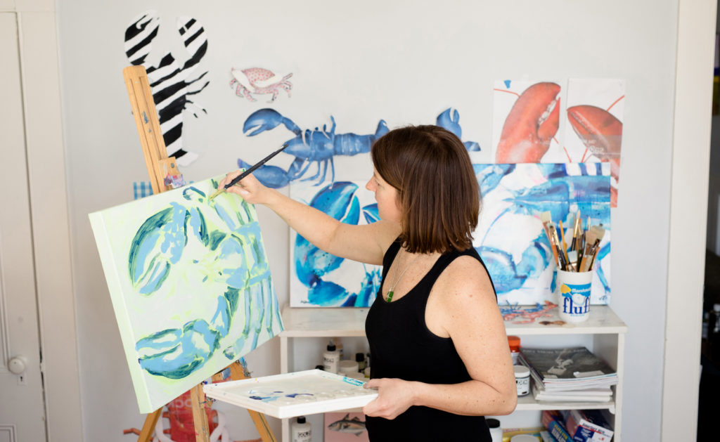 New England artist Mary Jo Mitchell working in her seaside studio. Photo courtesy of Eden Reiner Photography. 
