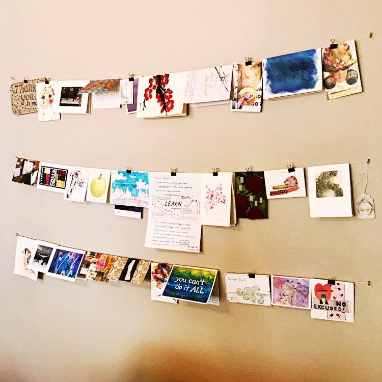 Alyson's wall of handmade cards from artists