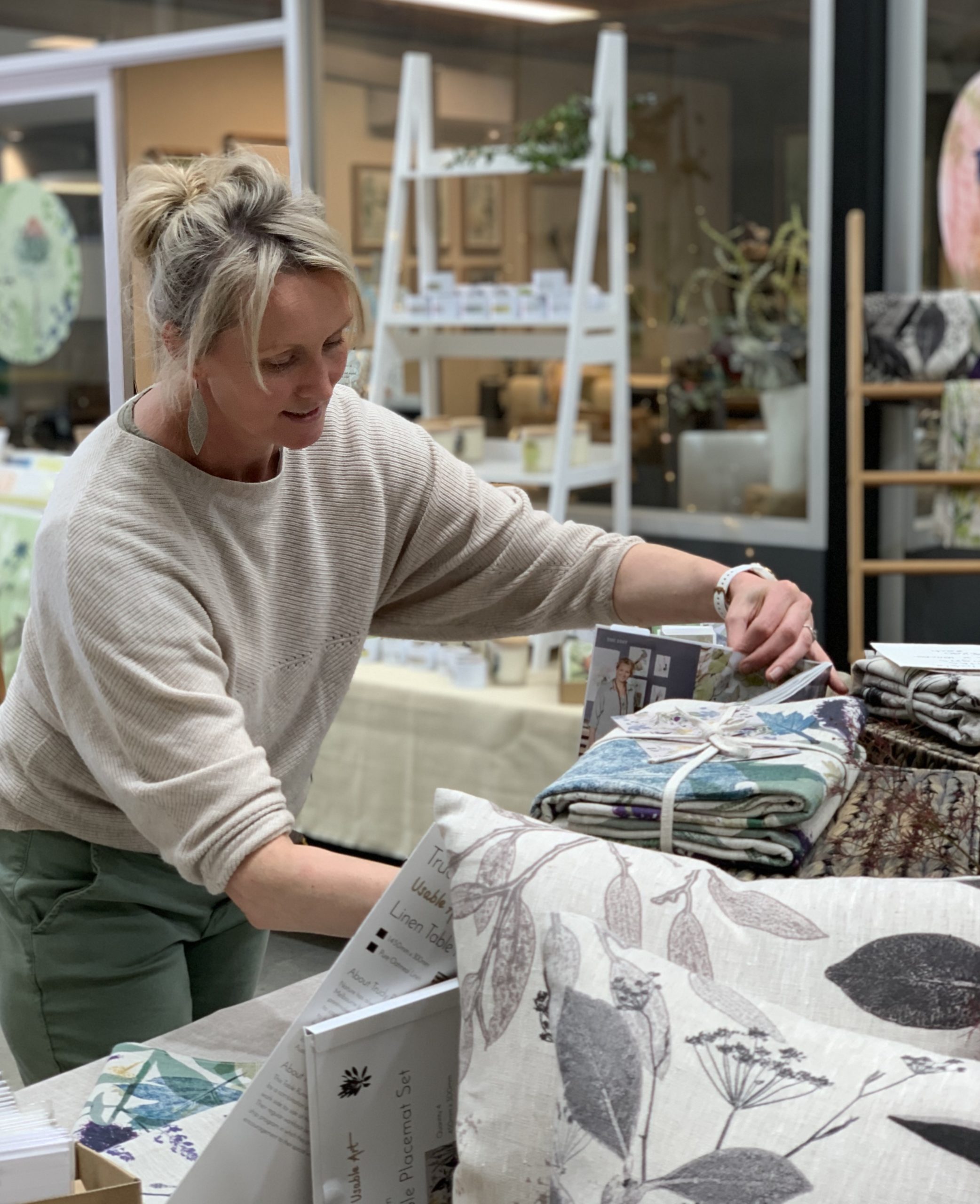 Trudy Rice checking a textile botanical print | on Art Biz Successin her studio