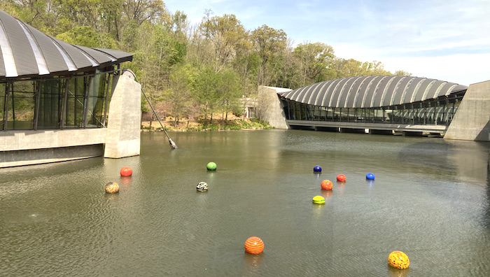 Floating glass orbs in water at Crystal Bridges Museum | on Art Biz Success