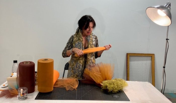 resident artist RedLine Ana Maria Hernando working in studio with textile pieces | on Art Biz Success