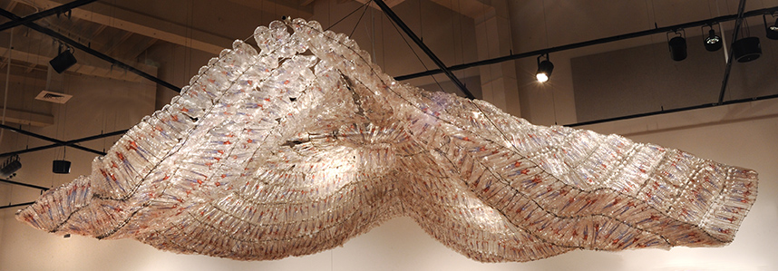 Sculpture of water bottles in serpentine shapes artist Willie Cole | on Art Biz Success