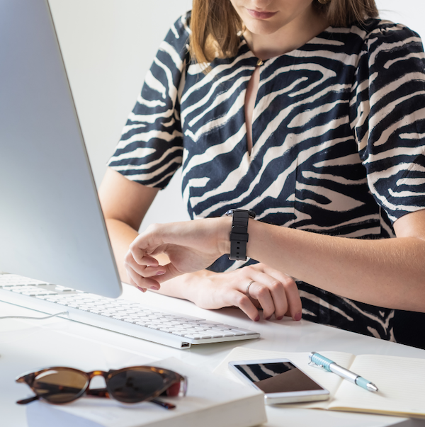 Woman looking at watch | Systematize Your Art Biz at Art Biz Success