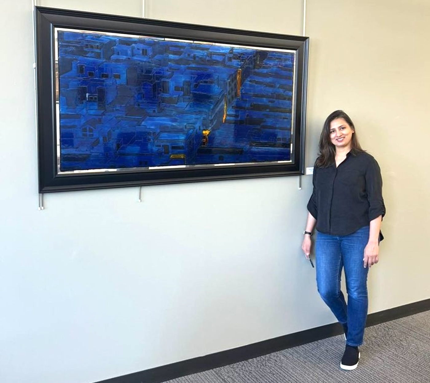Samra Bashir with her painting