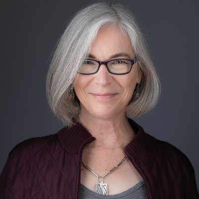 woman with gray shoulder length hair Kathryn Goldman headshot | on Art Biz Success